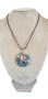 Abalone mother-of-pearl pendant in the shape of a pierced circle